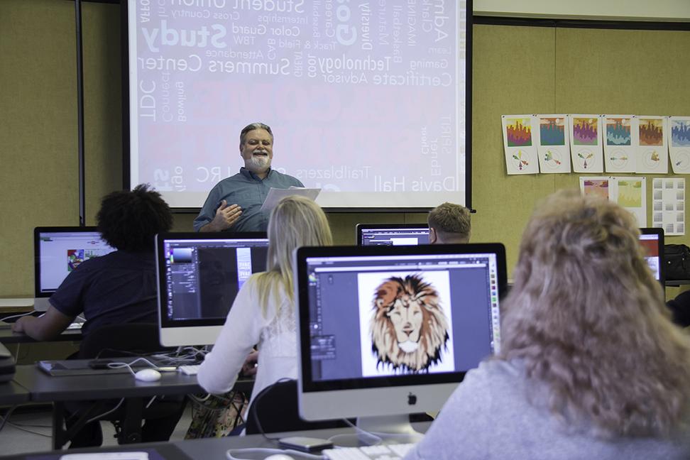 Instructor in graphic design class with students